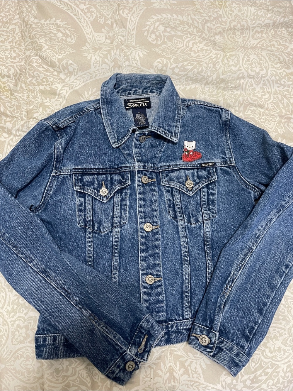 Squeeze Blue Denim Jacket with Hello Kitty acrylic pin on chest pocket.